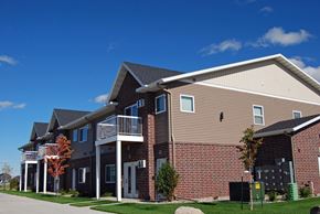 Moorhead apartment for rent - exterior of moorhead apartment, blue sky, green grass