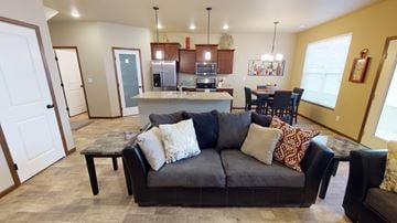 Moorhead townhouse for rent - a living room with a couch in front of a kitchen