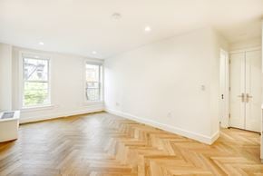 Brooklyn apartment for rent - A room with a wooden floor and white walls.