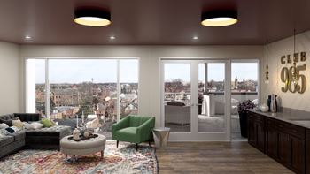 A living room with a view of a cityscape through large windows.