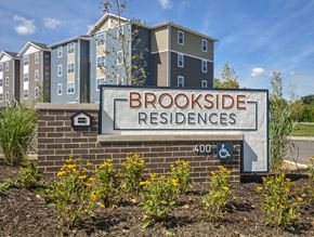 Cuyahoga Falls apartment for rent - a sign for brookside residences in front of an apartment building
