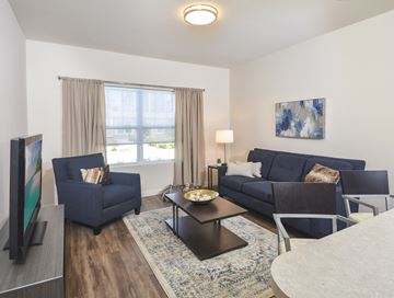 Cuyahoga Falls apartment for rent - a living room with couches and a table and a tv
