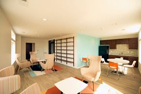 Washington apartment for rent - a lounge area with chairs and tables and a kitchen