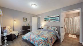 Greenville apartment for rent - A bedroom with a large bed and a dresser.