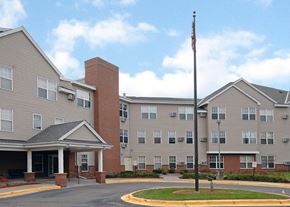 Minnetonka apartment for rent - an exterior view of an apartment building with a flagpole
