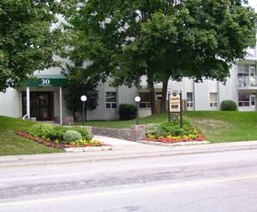 North York apartment for rent - A building with the number 30 on it is surrounded by greenery.