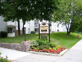 North York apartment for rent - A sign for St. Denis Drive is surrounded by flowers and greenery.