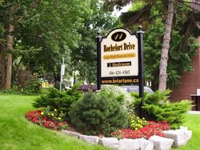 North York apartment for rent - A sign for Rochfort Drive with a garden in front.
