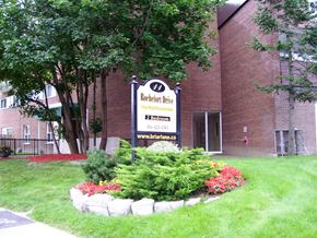 North York apartment for rent - A sign for Rochefort Drive is in front of a brick building.