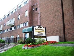 North York apartment for rent - A brick building with a sign that says Roefort Drive.