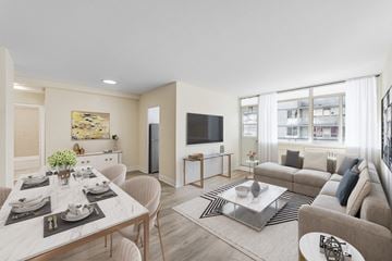 Toronto apartment for rent - A modern living room with a dining table set for two.
