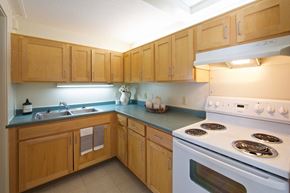 Colchester apartment for rent - a kitchen with white appliances and wooden cabinets