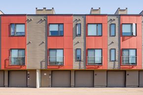 Winooski apartment for rent - the exterior of a building with red and gray facade and windows