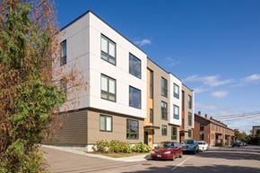 Winooski apartment for rent - a new apartment building on a city street with cars parked