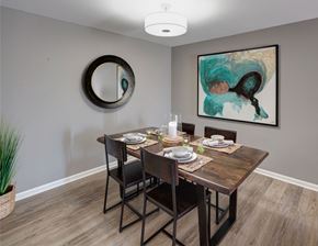 Carol Stream apartment for rent - wood table and wall art in a dining nook