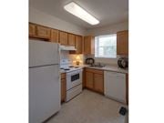 Dundalk apartment for rent - a kitchen with white appliances and wooden cabinets