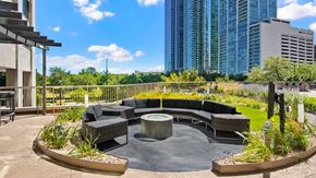 Chicago apartment for rent - Benches surround the fire pit. A television is on a stand nearby and the museum campus can been seen in the background.