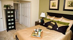 St. Louis apartment for rent - a bedroom with a bed and a tray of pillows