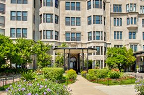 Chicago apartment for rent - A large building with a black gate and a small entrance.