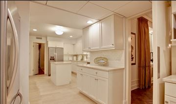 Chicago apartment for rent - A kitchen with white cabinets and a refrigerator.