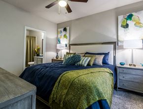 Cypress apartment for rent - a bedroom with a bed and a ceiling fan