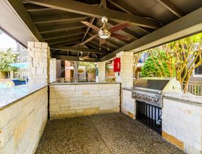 Cypress apartment for rent - the outdoor kitchen has a grill and a counter with a sink