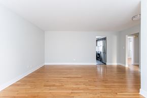 Chicago apartment for rent - a living room with a hard wood floor and white walls
