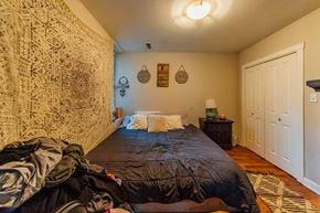 Chicago apartment for rent - a bedroom with a bed and a wall covered in graffiti