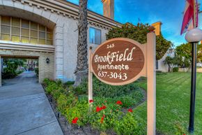 Orange apartment for rent - a sign that reads bookfield apartments in front of a building