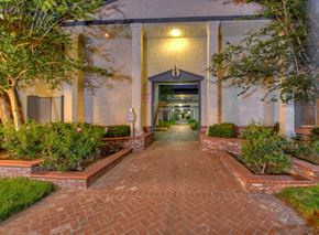 Orange apartment for rent - the walkway leading to the front entrance of a building