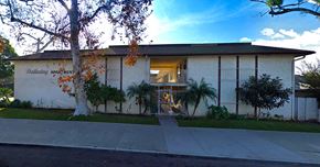 Santa Ana apartment for rent - a white building with a sidewalk in front of it