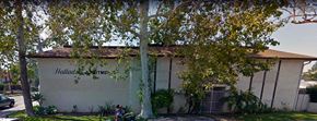 Santa Ana apartment for rent - a white building with trees in front of it
