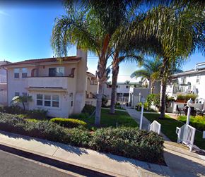 Laguna Beach triplex for rent - a street with palm trees in front of houses