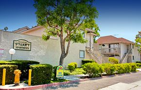 Garden Grove apartment for rent - a building with a street sign and a tree in front of it
