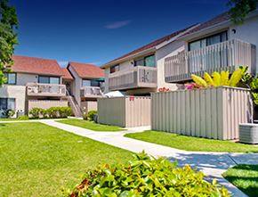 Garden Grove apartment for rent - a row of houses with balconies and a lawn