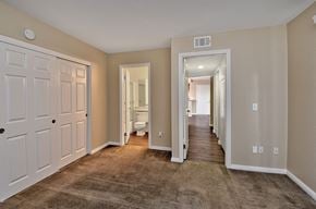 Riverside apartment for rent - a spacious hallway with a carpeted floor and white doors