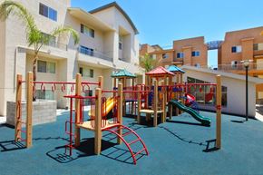 San Diego townhouse for rent - Community playground with light gray and tan building exterior in background.
