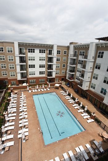 Hotel-inspired pool with lounge areas, bbq grilling stations, picnic area, and outdoor ping-pong table