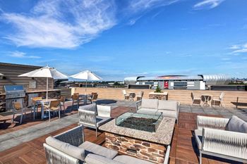 Rooftop lounge with bbq grilling stations, seating areas, outdoor billiards, fire pit and double-sided fireplace