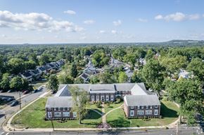 Millburn apartment for rent - a view of a building from the air with a street and trees