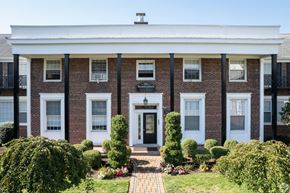 Millburn apartment for rent - the front of a brick building with a white porch