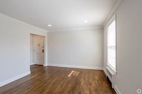 Millburn apartment for rent - an empty living room with white walls and wood floors