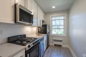 Millburn apartment for rent - an empty kitchen with a stove and a microwave