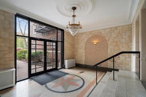 Cranford apartment for rent - the lobby of a building with glass doors and a chandelier