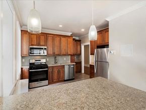Cranford apartment for rent - A kitchen with wooden cabinets and stainless steel appliances.