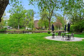 Cranford apartment for rent - a park with tables and umbrellas next to a pond