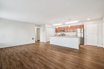 Happy Valley apartment for rent - A kitchen with white cabinets and a wooden floor.
