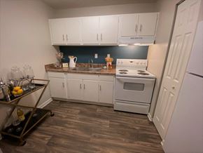 Asheville apartment for rent - a kitchen with white appliances and white cabinets