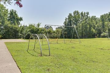 Chesapeake apartment for rent - A playground with a swing set and a walkway.