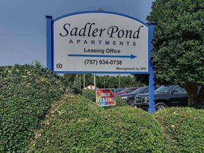 Suffolk apartment for rent - a sign for saunders pond apartments in front of a parking lot
